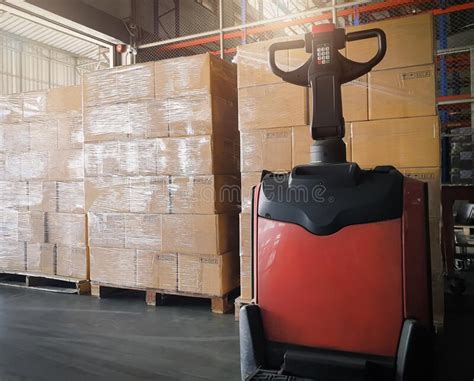 Stack Of Shipment Boxes And Electric Forklift Pallet Jack At The Warehouse Cargo Export