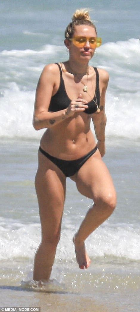 Miley Cyrus Turns Heads With Her Remarkable Toned Figure In A Sultry Black Bikini At Byron Bay