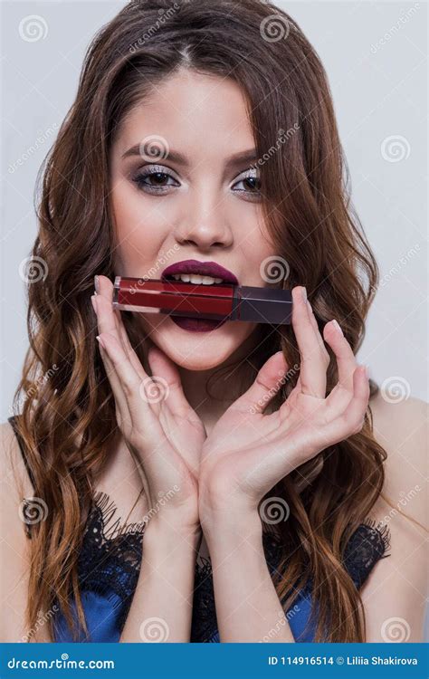 Beautiful Brunette Girl Advertises Red Lipstick Bites Her Lip Gloss