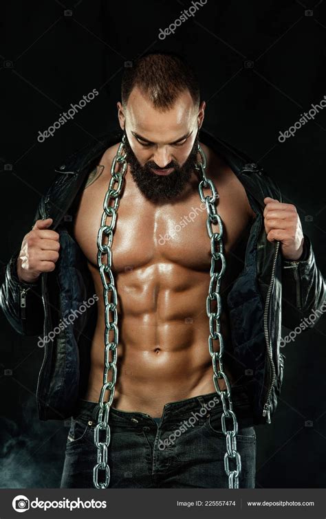 Men Fashion Close Up Portrait Of A Brutal Bearded Man Topless In A Leather Jacket With Chains