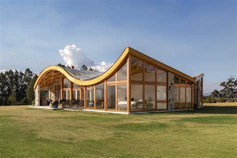 The Wavy Roof On This House Also Has An Exposed Wood Structure On The