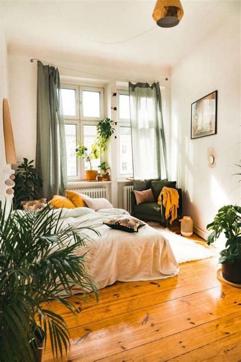A Bed Room With A Neatly Made Bed And Lots Of Plants