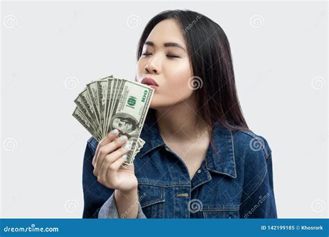 Loving Money Portrait Of Satisfied Attractive Young Businesswoman In Blue Denim Jacket Standing