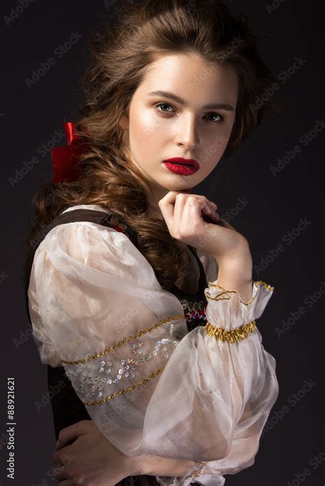 Beautiful Russian Girl In National Dress With A Braid Hairstyle And Red