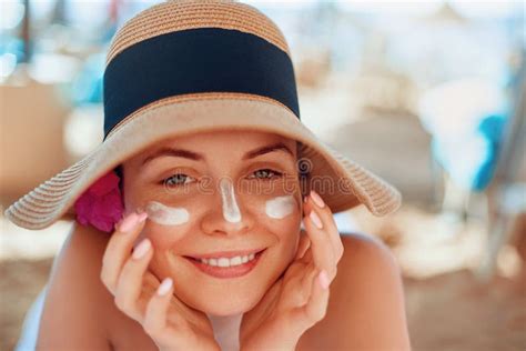 woman smile applying sun cream on face skincare body sun protection sunscreen stock image