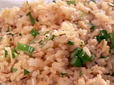 Close up of moist, moroccan rice pilaf with carrots. Herbed Brown Rice Pilaf Recipe | The Neelys | Food Network