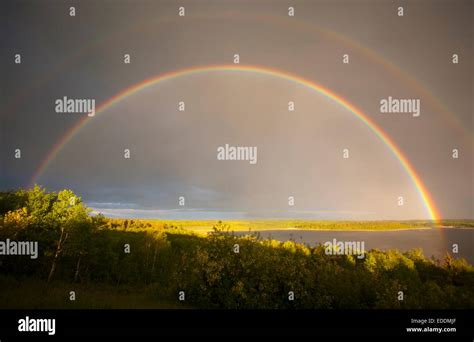 A Double Rainbow In The Sky Arching Over The Land Stock Photo Alamy