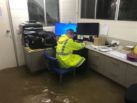 Ambulance Officer Sits In A Flooded Office During Record Breaking