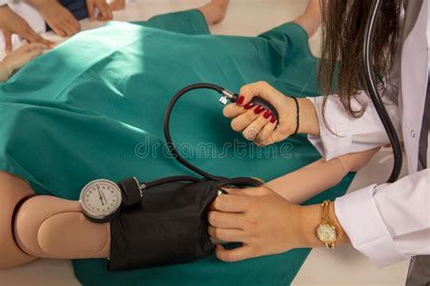 Measuring Blood Pressure With A Sphygmomanometer Close Up Shot Stock