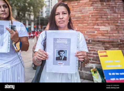 protesters hold pictures of victims of the colombian army during the