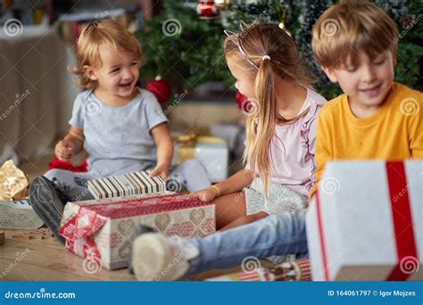 Cute Kids Opening Christmas Gift at Home Stock Image  Image of people