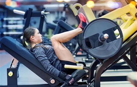 Woman Flexing Muscles On Leg Press Machine In Gym Stock Image Colourbox