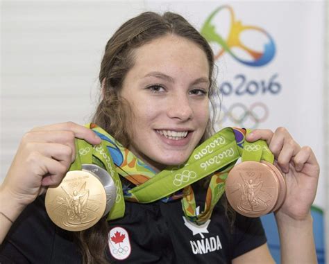 16 Year Old Penny Oleksiak Holding Up Her Gold Silver And Two Bronze