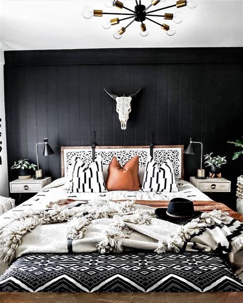 The Dark Wall Contrasts Against The White Bed And Blankets To Make A