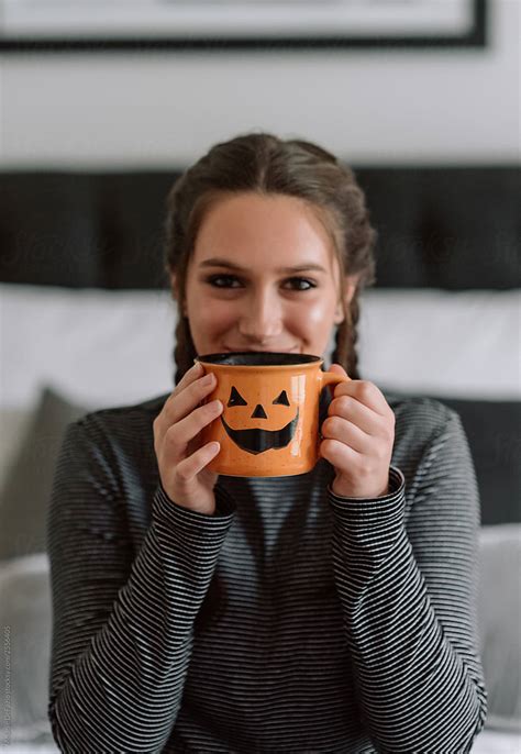 Girl Drinking Hot Chocolate In A Halloween Mug By Stocksy Contributor Melanie Defazio Stocksy