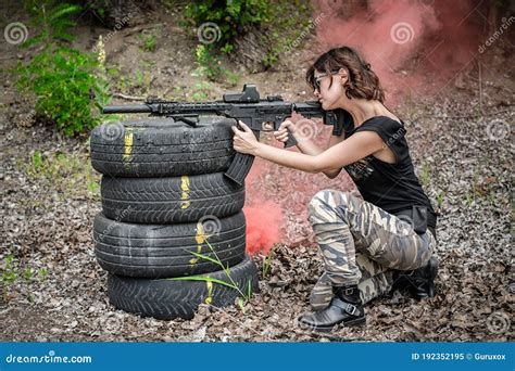 Attractive Woman Shooting With Rifle Machine Gun From Behind Barricade