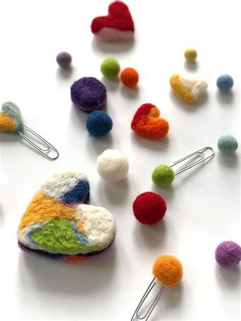 Several Pins Are Arranged In The Shape Of A Heart And Colorful Felt