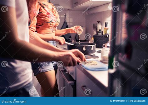 couple cooking in home kitchen two people preparing a meal and dinner together husband and