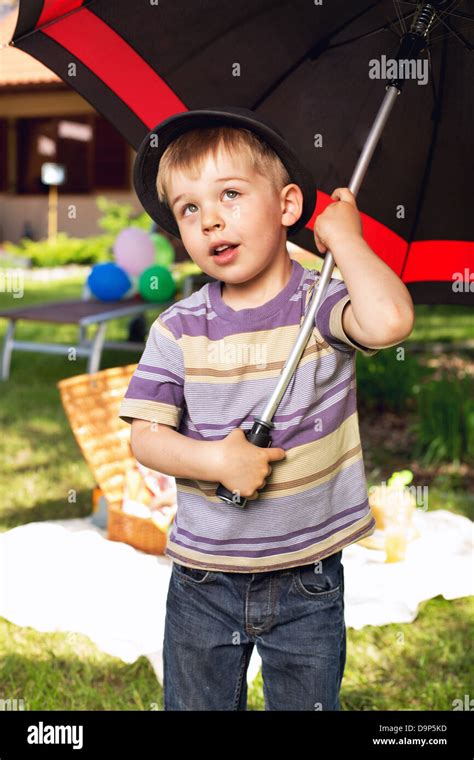 Curious Little Boy With Big Umbrella Stock Photo Alamy