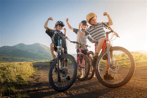 Three Boys Are Proud And Excited About Their Mountain Biking Run Near