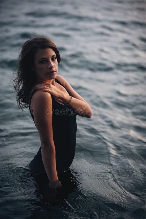 Seductive Model In The Dress Standing In The Sea Water Stock Photo