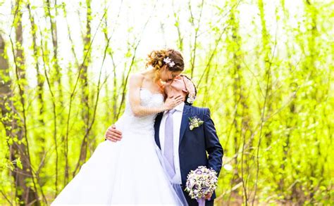 Bride And Groom At Wedding Day Walking Outdoors On Spring Nature