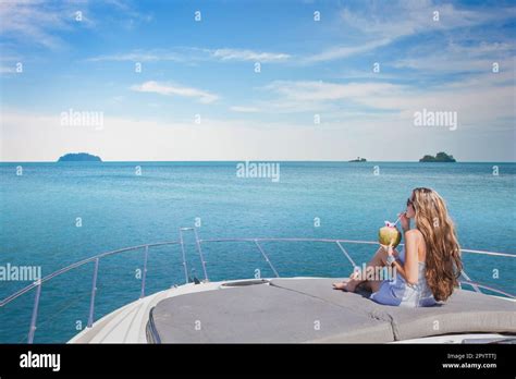Luxury Travel Woman Relaxing On Luxurious Boat And Drinking Coconut