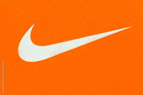 White Nike Logo On Orange Background Stock Photo Adobe Stock