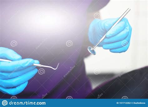 In The Office Of The Dental Clinic The Doctor Holds Tools For