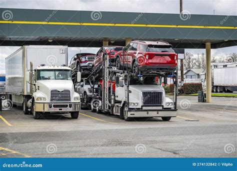 Industrial Car Hauler Big Rig Semi Truck Transporting Cars On The Semi
