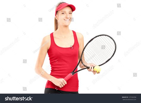 A Smiling Female Holding A Tennis Racket And A Ball Isolated On White