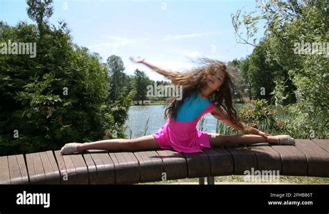 Girl Gymnast Doing Exercises In The Park Stock Video Footage Alamy