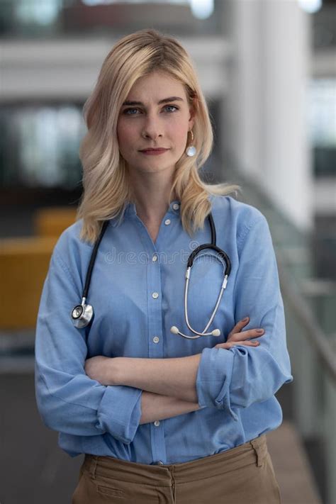 Blonde Female Doctor With Arms Crossed Looking At Camera In Clinic Stock Image Image Of