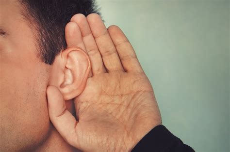 Premium Photo Listening Male Holds His Hand Near His Ear Concept Of