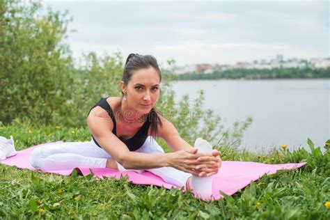 Woman Holding Legs Apart Doing Exercises Aerobics Warming Up With Gymnastics For Flexibility Leg