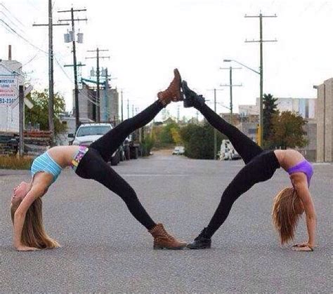 Two Women Doing Handstands In The Street