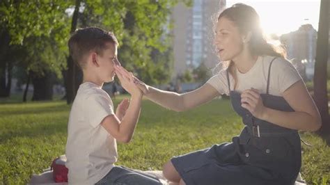 Older Sister Spending Time With Younger Brother Outdoors Stock Video Envato Elements