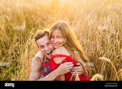 Teenage Girlfriend And Boyfriend Having Fun Outdoors Kissing Hugging