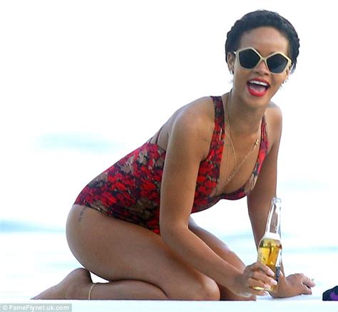 rihanna shows off her curves in a red swimsuit as she tries out different poses daily mail online