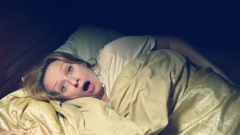 Horror In Horror The Girl Wakes Up At Night In Her Bed Stock Photo