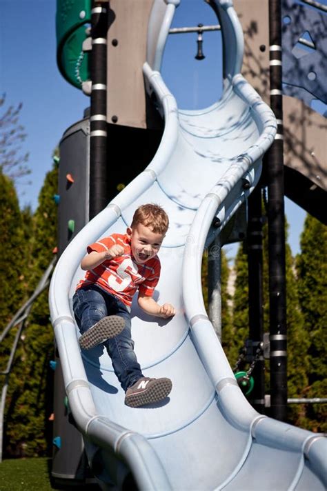 Little Boy On The Playground Slide Stock Image Image Of Enjoy