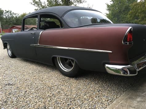 An Old Car Is Parked On The Gravel