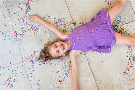 Free Photo Overhead View Of Happy Cute Girl Lying With Confetti On Floor