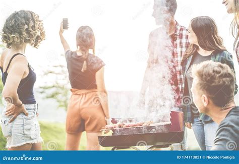 Millennial Friends Taking Selfie On Barbecue Fire At Backyard Outdoor Dinner Party Young