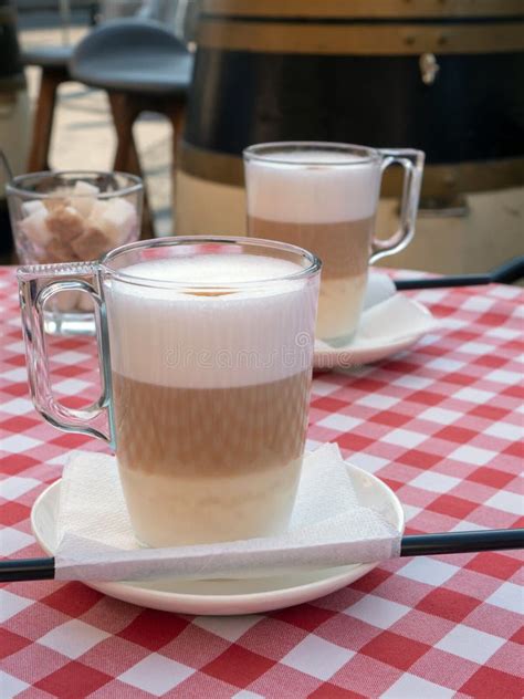 Frothy Layered Cappuccino In A Clear Glass Mug Tempting Coffee Latte