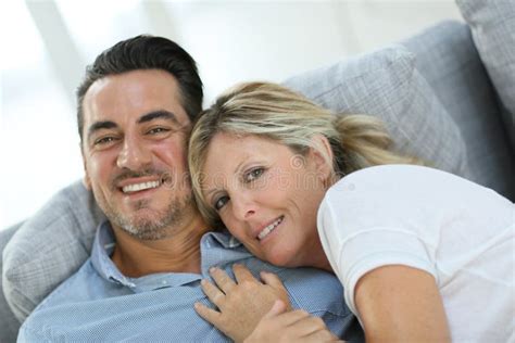 Smiling Mature Couple Relaxing On Sofa Stock Image Image Of Embracing Lifestyle 64657381