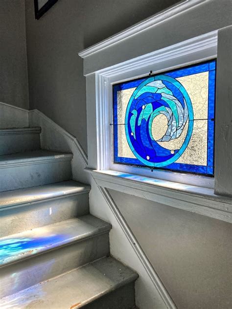 Deep Blue Cresting Wave Design Installed In A Stairway Window