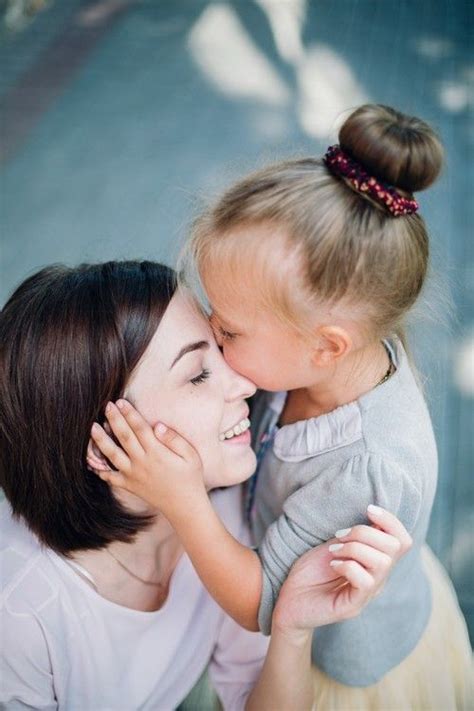 an adorable daughter kissing her mother mother daughter bond mother daughter momcanvas mom