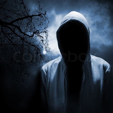 Dangerous Man Hiding Under The Hood In The Dark Night Forest Stock