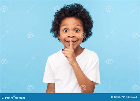 Shh Be Quiet Portrait Of Funny Cute Little Boy With Curly Hair In T